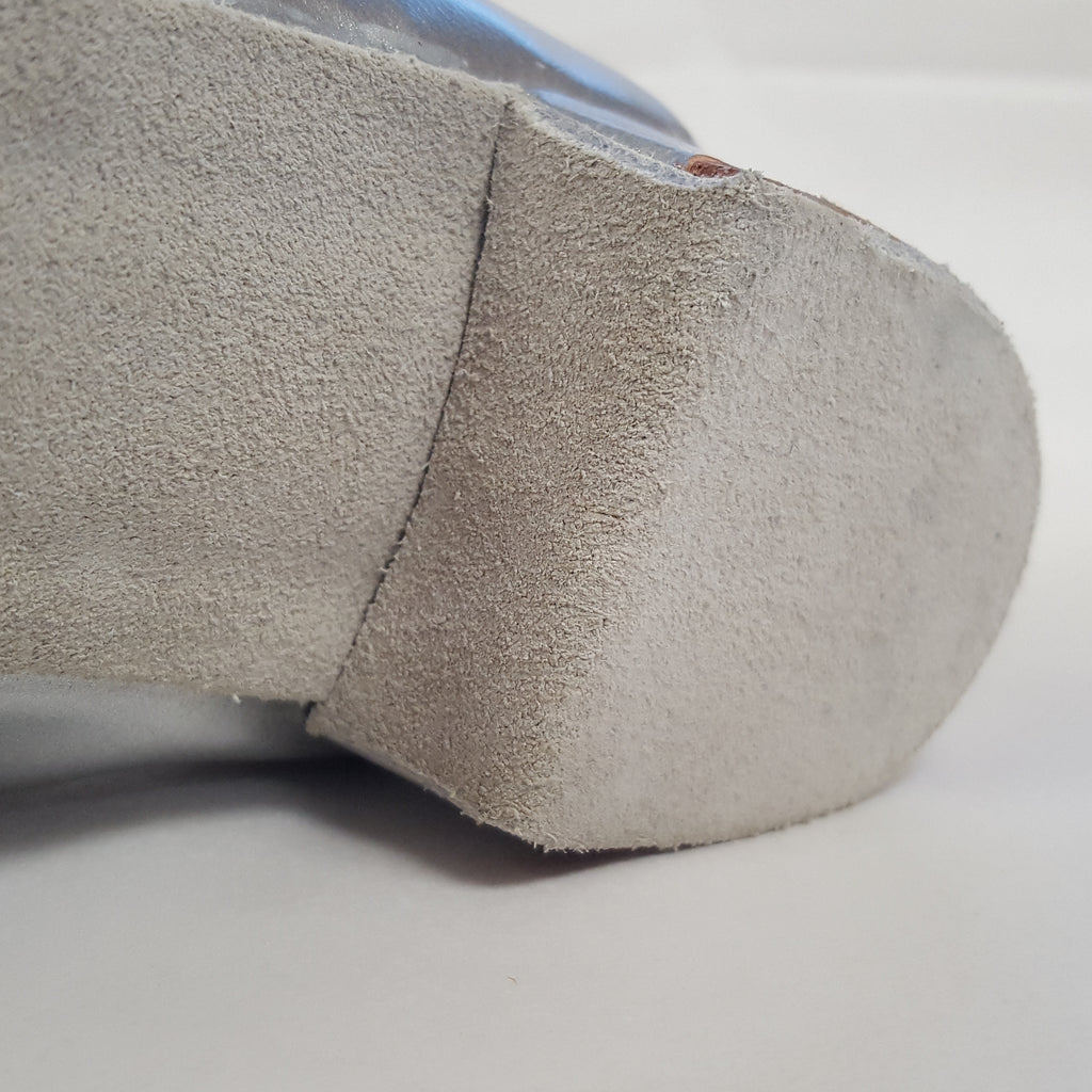 Suede soles wrapped over the front of the heel.